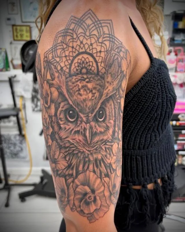 Heather Baldwin black and grey owl tattoo with mandala and floral half-sleeve in Hawaii
